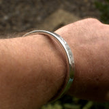 heavyweight solid silver bangle on wrist