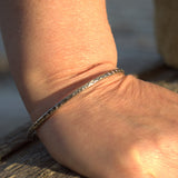 silver slim patterned bangle on wrist