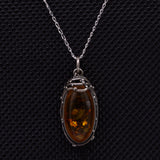 Amber silver pendant featuring wirework and delicate silver balls