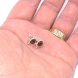 925 silver Garnet ear studs shown in hand