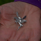Art Nouveau style solid silver faery brooch held in hand