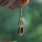 Garnet and gold Celtic pendant side view