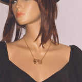solid 9ct gold triple bar pendant necklace shown on model