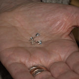 Aquamarine ear studs shown in hand