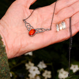 Celtic solid 925 silver pendant necklace featuring an Amber stone shown in hand