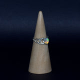 Celtic solid 925 silver and Ethiopian Opal ring shown on ring display, side view