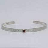 Garnet and textured silver open bangle