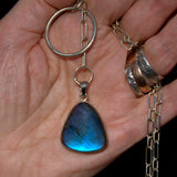 solid silver blue Labradorite lariat necklace shown in hand