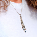 Sapphire and silver pendant necklace shown on model