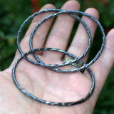 set of three interconnected silver bracelets