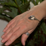 solid 925 silver Calla Lily bangle shown on  wrist
