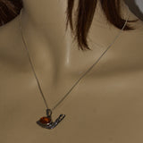 silver snail pendant featuring Amber