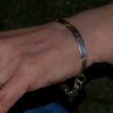 textured solid silver link bracelet shown on wrist