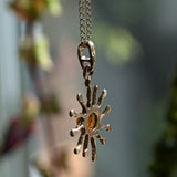 solid gold and Amber sun pendant side view