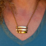 solid 375 yellow gold triple bar pendant necklace shown on model
