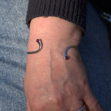 solid silver Garnet twist bangle on wrist