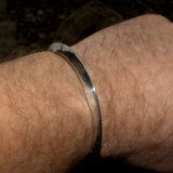 silver triangular profile bangle on wrist