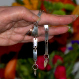 textured sterling silver link bracelet shown in hand