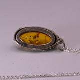 open back bezel set Amber silver pendant, back view