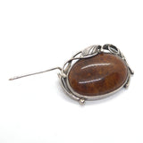 Amber and silver brooch with pin open