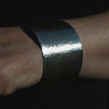 silver textured open cuff bangle on wrist