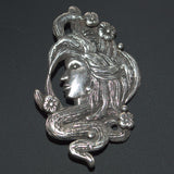 silver flowing hair and flowers head brooch