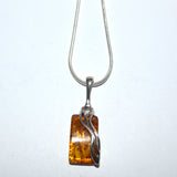 Amber and silver wave design pendant necklace